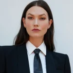 Headshot image of Karlie Kloss in suit looking at camera