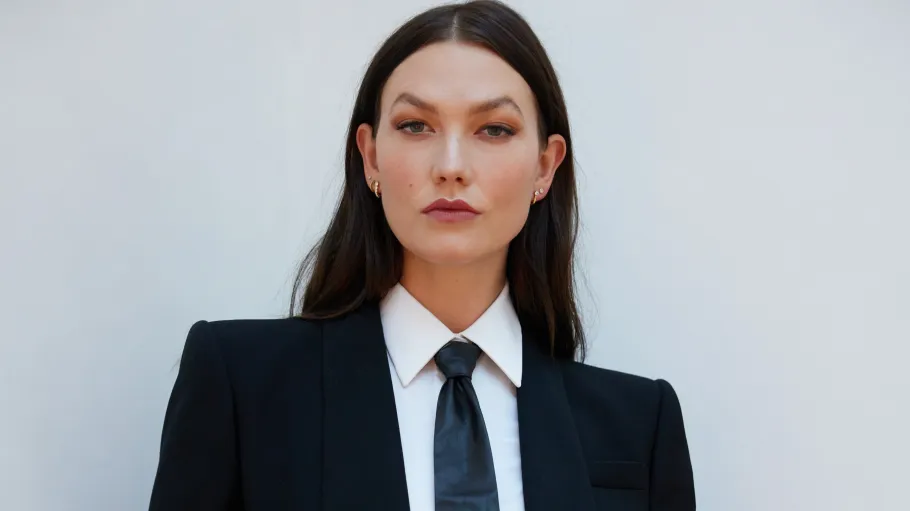 Headshot image of Karlie Kloss in suit looking at camera